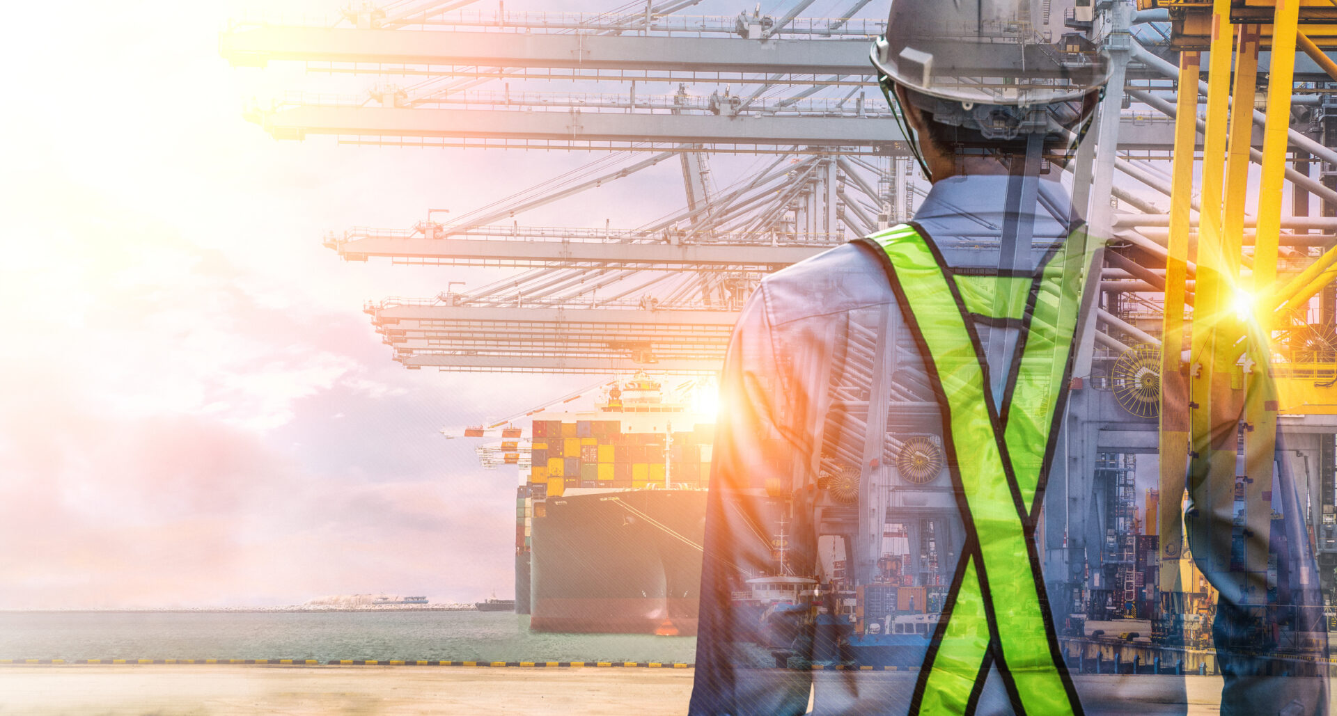 A man in safety gear standing on top of a road.