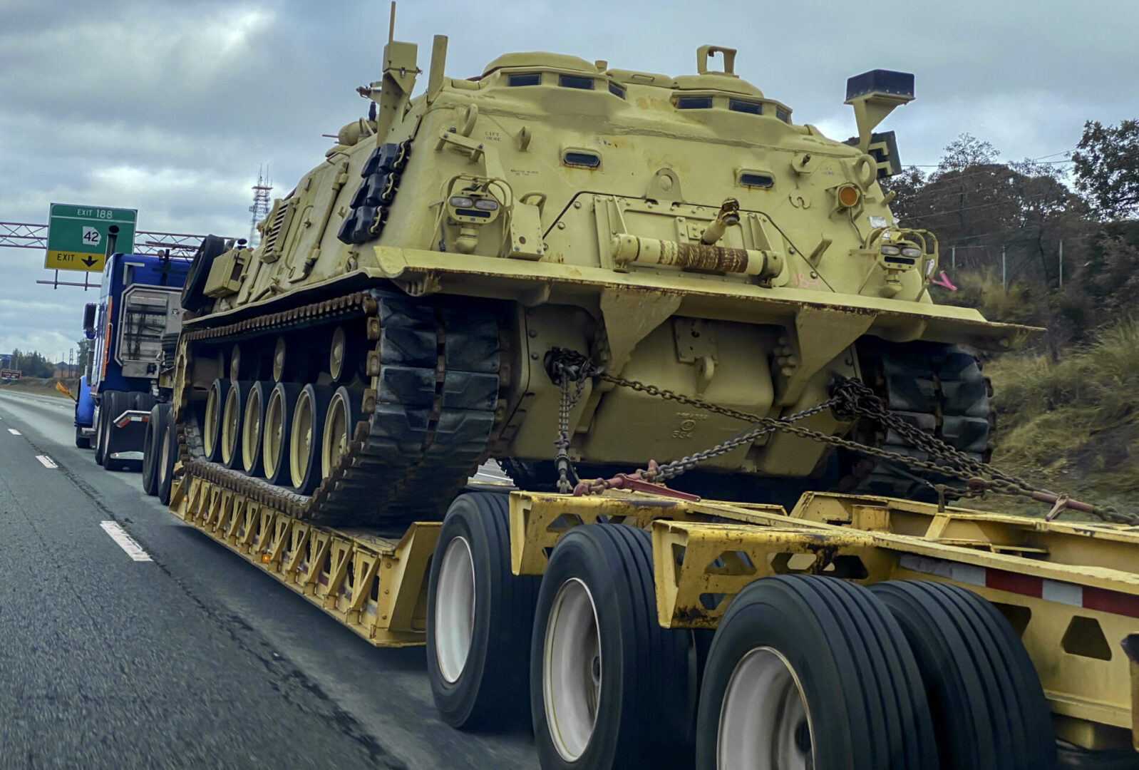 A large yellow truck with a tank on it's back.