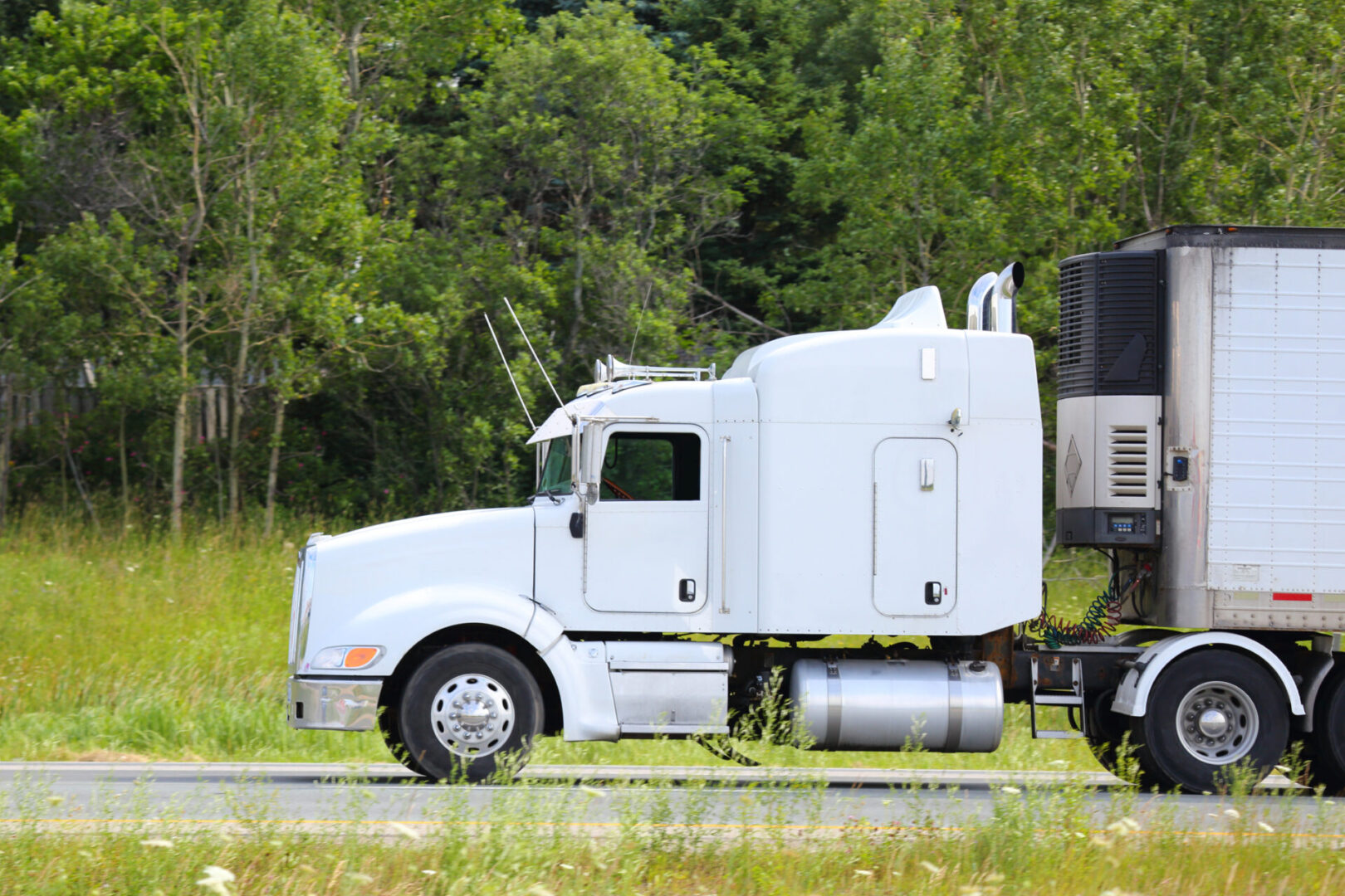 A white truck is parked on the side of the road.